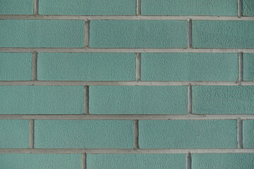 Texture of blue green brick wall with light grey mortar joints