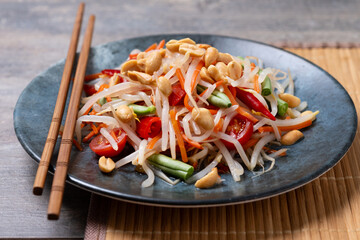 Green Papaya Salad, som tam thai on wooden table