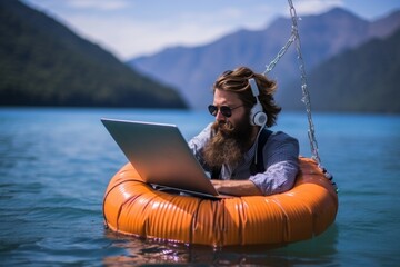 Remote occupation. freelancer on inflatable ring, working with laptop in tropical sea