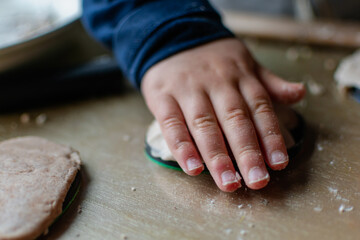 Child having fun modeling salt dough, authentic activity, fine motor skills development