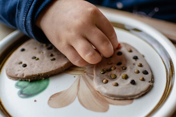 Child having fun modeling salt dough, authentic activity, fine motor skills development