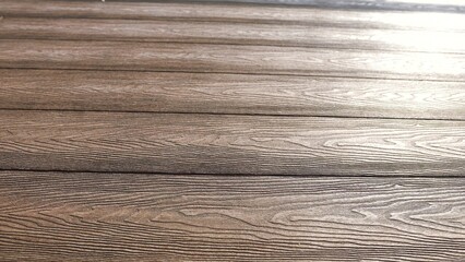 The floor in the house with a quality parquet or laminate wood texture brown board