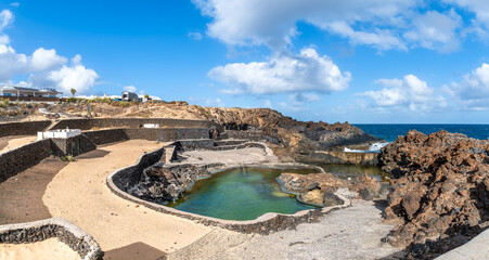 Discover Charco del Palo, unique coastal pools set amidst Lanzarote's striking volcanic landscapes, a serene escape for nature enthusiasts
