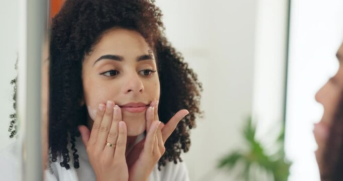 Woman, mirror and cream in face, beauty and morning routine with skincare and wellness at home. Cosmetic product, reflection for facial mask and self care with dermatology or moisturizer in bathroom