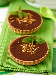 Chocolate tartlets with pistaccios,