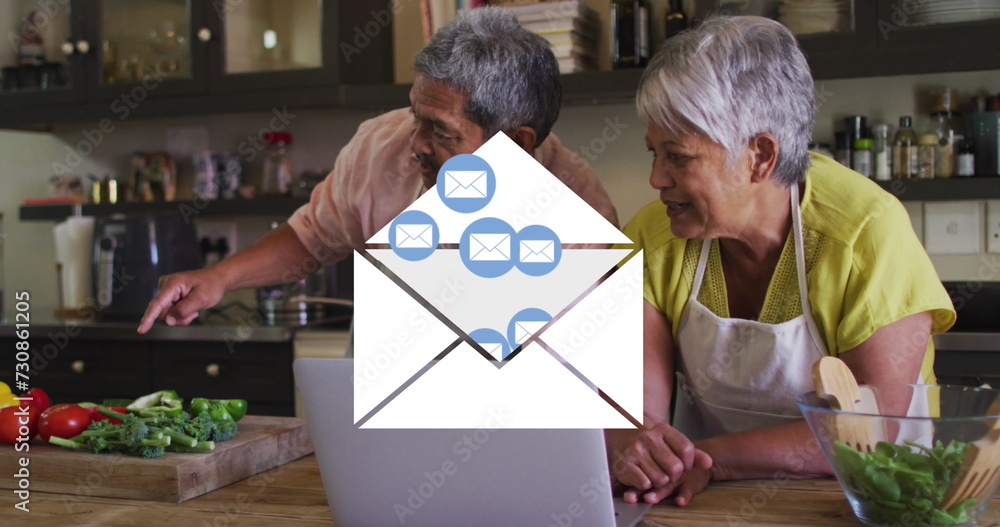 Poster Image of envelope mail icons over senior couple using laptop at home