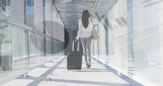 Image of financial data processing over biracial businesswoman in airport