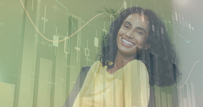 Image of financial data processing over smiling biracial businesswoman