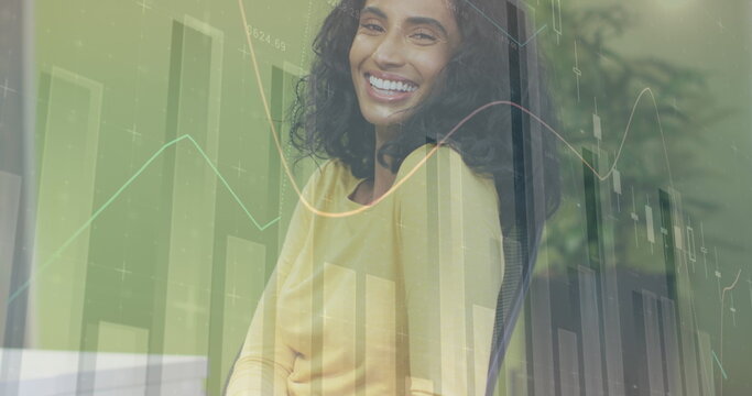 Image of financial data processing over smiling biracial businesswoman