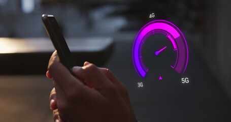 Image of purple speedometer over hands of caucasian man using smartphone