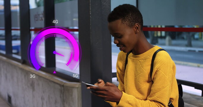 Image of purple speedometer over happy african american boy using smartphone