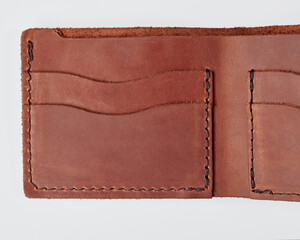 Open brown leather wallet with pockets for cards and drivers license