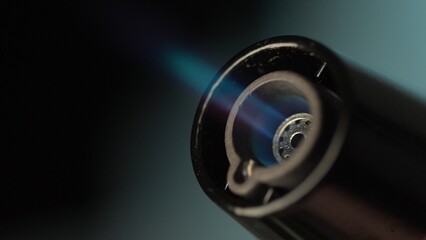 Butane Torch Lighter emits a Blue Flame. Macro shot, Shallow DOF.