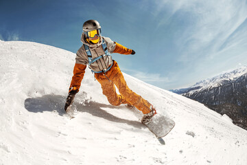 Fast happy professional snowboarder rides at off-piste ski slope