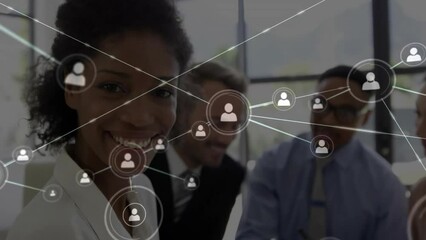 Animation of network of people icons over happy diverse colleagues at office