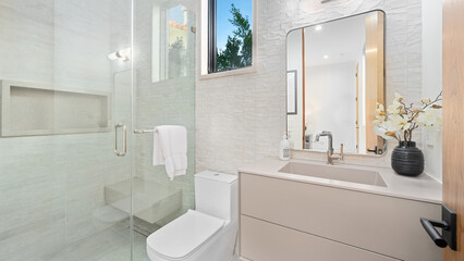 Modern bathroom with a walk-in shower and a beige vanity
