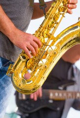 close-up of thestreet musician playing the saxophone on a bright sunny day	