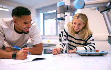 Obraz premium Male And Female College Or University Engineering Students In Robotics Class Working Together