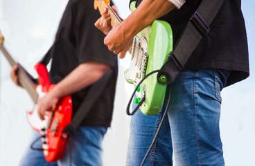 close-up of the hands of a musician playing an electric guitar	

