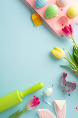 Easter pastry prep. A vertical top view of a baking setup with tools, adorable cookie cutter, eggs...