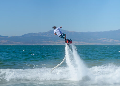 The guy flyboarding on the lake.