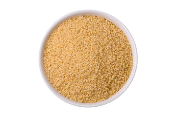 Wheat porridge couscous grains on a dark concrete background