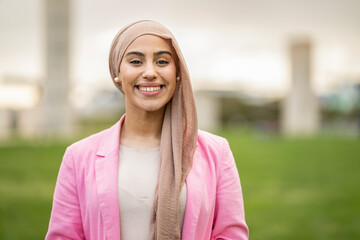 Portrait beautiful Middle Eastern woman with hijab with toothy smile looking at camera