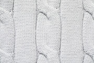 Texture of soft light knitted fabric as background, top view
