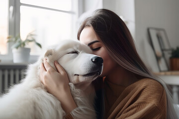 Happy woman kissing dog
