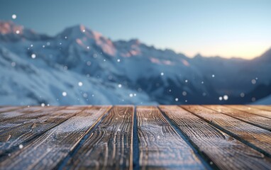 Empty wooden deck table against view of snowy mountain range