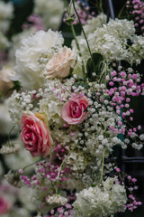 Valmiera, Latvia - July 7, 2023 - Close-up of a floral arrangement with pink roses and white blooms.