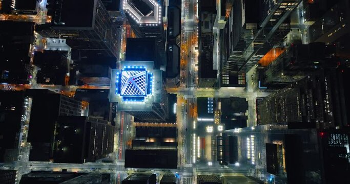 Aerial of skyscraper tower BNY Mellon Center at night. Reveals cityscape lights and traffic. Birds eye drone view. City of Philadelphia.