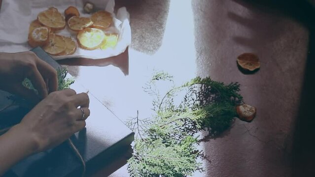 DIY gift wrapping and decoration using dried citrus, pine leaves and twine for a rustic, zero waste and sustainable Christmas