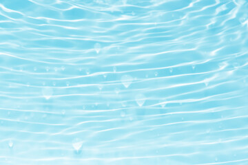 Water surface. Bluewater waves on the surface ripples blurred. Defocus blurred transparent blue colored clear calm water surface texture with splash and bubbles. Water waves with shining pattern.