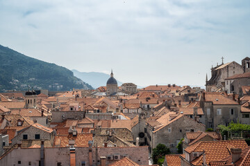 Fototapeta na wymiar Amazing panoramic view of picturesque Dubrovnik old town, towers, narrow stone streets and buildings with red roofs on Adriatic sea coast, Croatia.