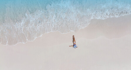 Fresh of summer with young woman  relaxation  as lying on the beach  in Maldives