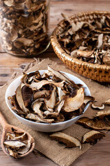Collect and dry mushrooms in autumn, porcini mushrooms - a delicious ingredient for sauces and goulash on a wooden table