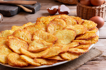 Potato pancakes or latkes on a wooden background