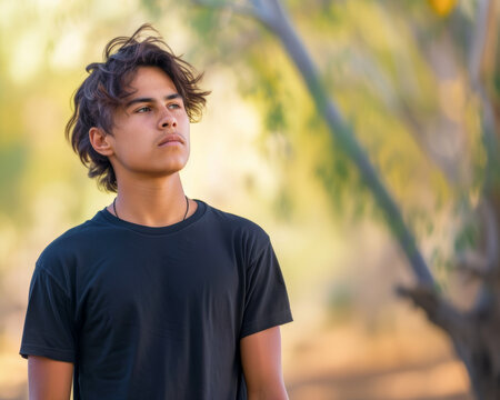 A young man basking in the shade and appreciating nature.