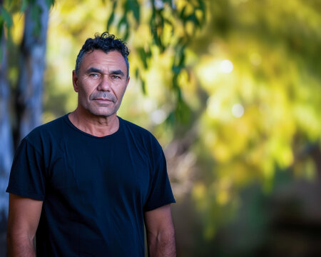 Man standing in front of tree.