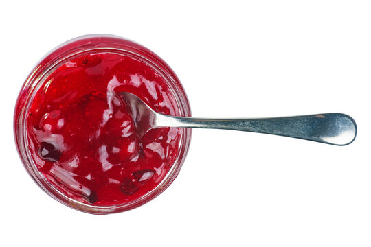 Cranberry jam in glass jare with spoon isolated on a white background .Top view