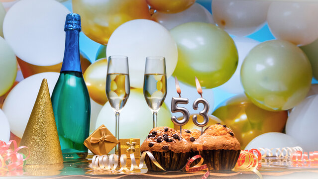 Happy birthday champagne background with number of candles  53. Beautiful congratulations copy space for anniversary..Holiday decorations with balloons with a bottle of champagne in pastel colors.