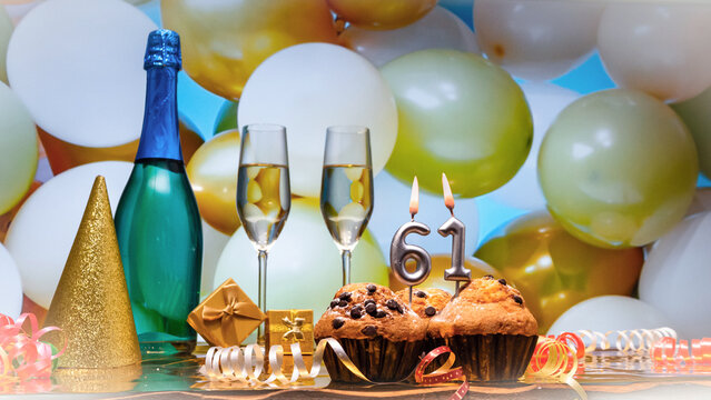 Happy birthday champagne background with number of candles  61. Beautiful congratulations copy space for anniversary..Holiday decorations with balloons with a bottle of champagne in pastel colors.