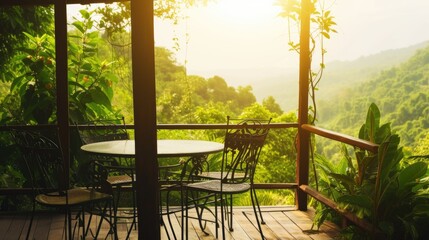 A table and chairs on a deck with a view of the mountains