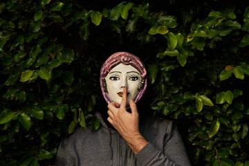 man with ceramic mask gesturing
