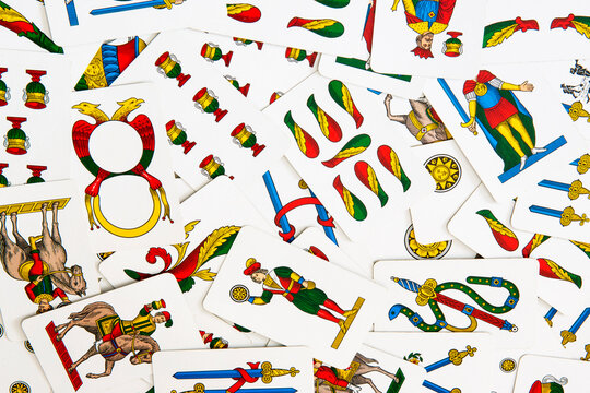 Spanish-suited playing cards. The Neapolitan pattern widely used in central and southern Italy. Zenith view on bulk playing cards. Ideal for background or backdrop. Card games.