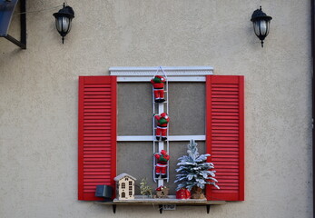 fake window with red shutters and Christmas decoration