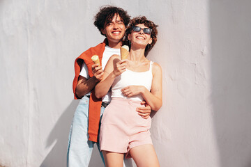 Smiling beautiful woman and her handsome boyfriend. Woman in casual summer clothes. Happy cheerful...