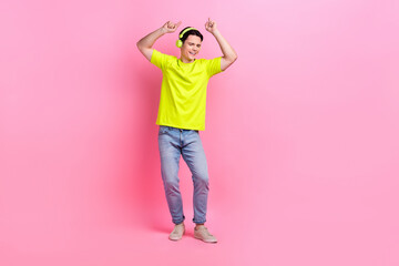 Full length photo of cheerful funky man dressed yellow t-shirt headphones dancing listening music...
