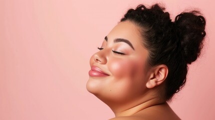 A close-up of a woman with a radiant smile closed eyes and a soft blush on her cheeks set against a soft pink background showcasing her beauty and serene expression.
